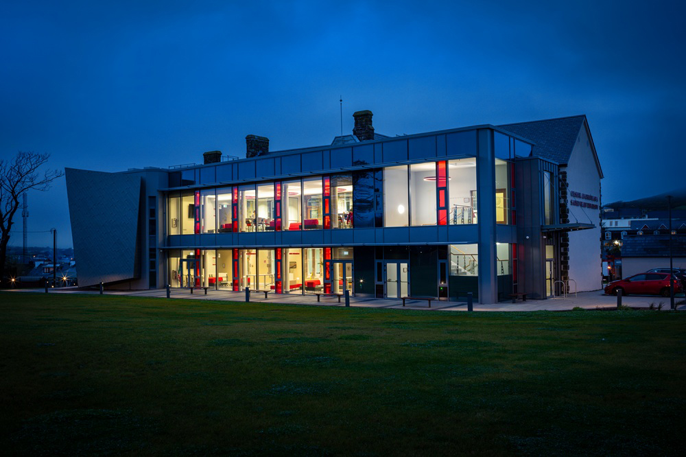 Picture of a building at dusk lit up