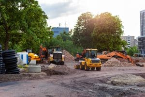 Modular classroom groundworks Urban construction site with excavator